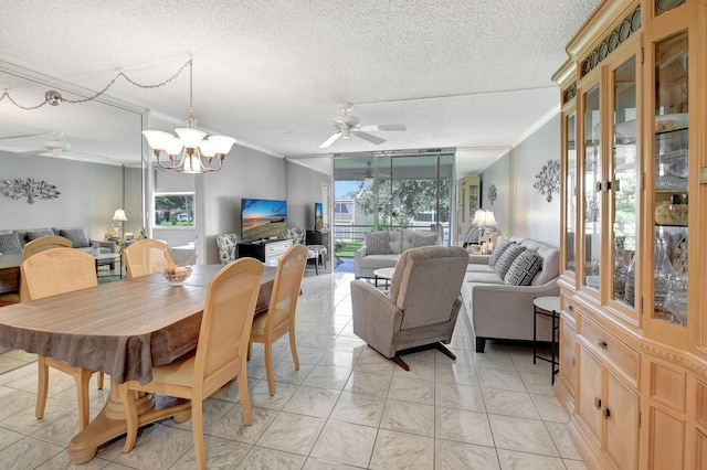 tiled dining area with a textured ceiling, ceiling fan with notable chandelier, and crown molding