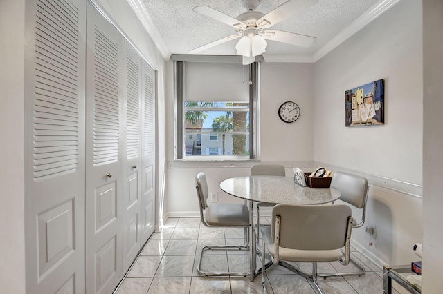 dining space featuring a textured ceiling, ceiling fan, and crown molding