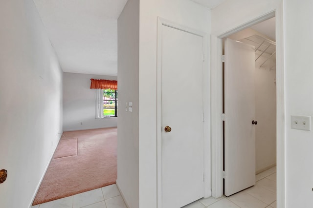 hallway featuring light colored carpet