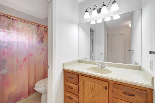 bathroom with tile patterned flooring, vanity, and toilet