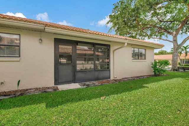 rear view of property featuring a yard