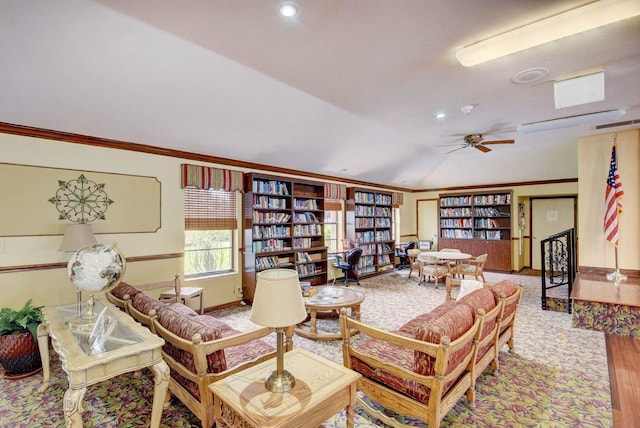 living room featuring wood-type flooring, lofted ceiling, ornamental molding, and ceiling fan