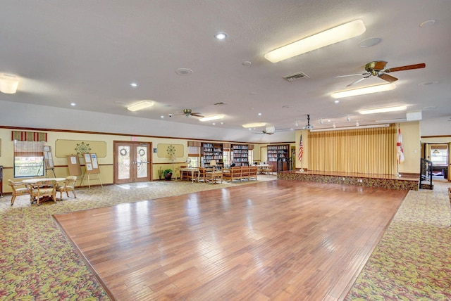 miscellaneous room with ceiling fan, french doors, hardwood / wood-style floors, and a wealth of natural light