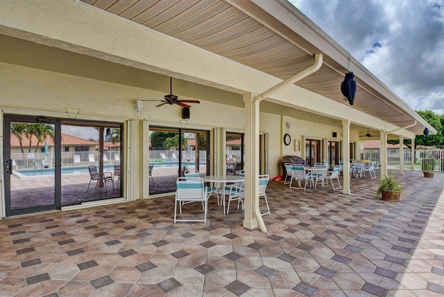 view of patio featuring ceiling fan and a community pool