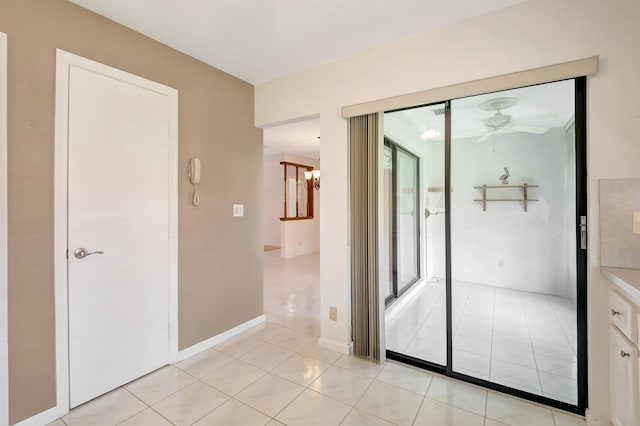 entryway featuring ceiling fan and light tile patterned floors