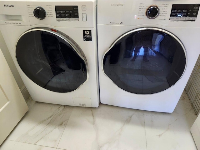 clothes washing area featuring washing machine and clothes dryer