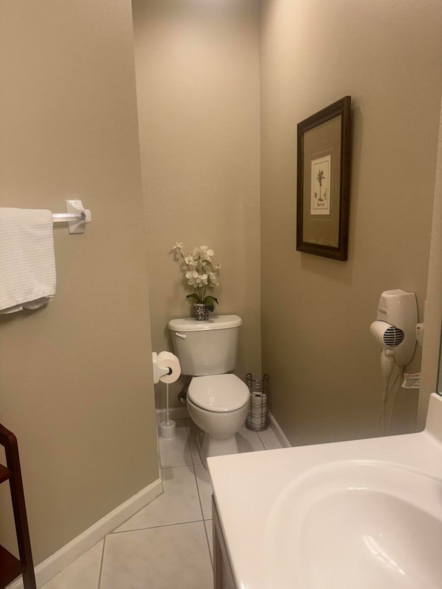 bathroom featuring vanity, tile patterned flooring, and toilet