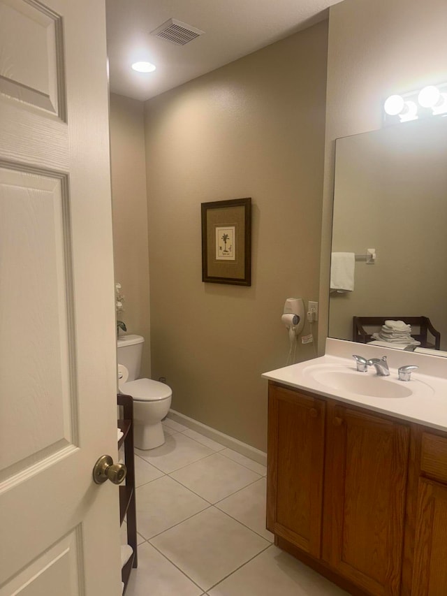 bathroom featuring tile patterned floors, vanity, and toilet