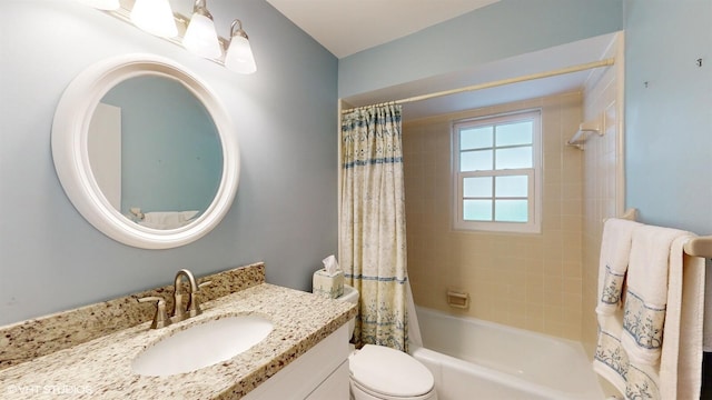 bathroom featuring toilet, vanity, and shower / bath combination with curtain