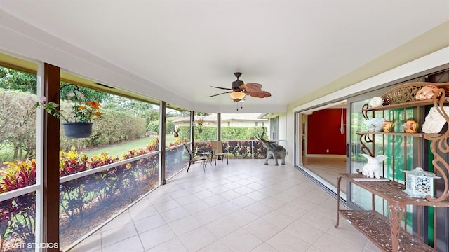 sunroom featuring ceiling fan