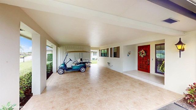 exterior space featuring visible vents and stucco siding