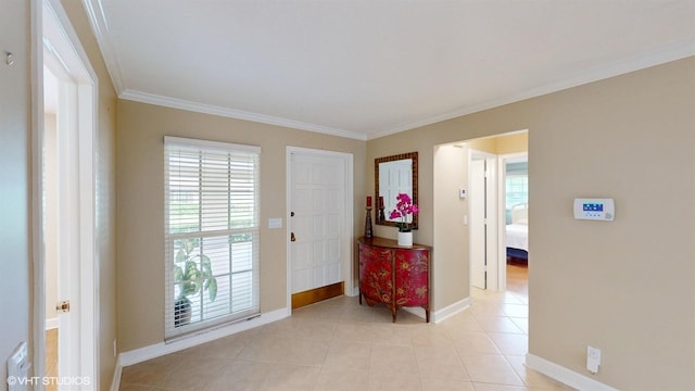 entrance foyer with baseboards, ornamental molding, and plenty of natural light