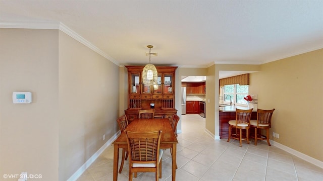 dining space with light tile patterned floors, baseboards, and crown molding