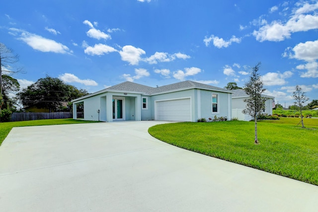 view of front of house with a garage and a front lawn