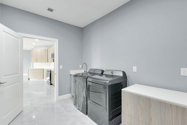 1749 SW California Blvd, Port Saint Lucie, FL 34953 - laundry area featuring washing machine and dryer, light marble finish flooring, and baseboards