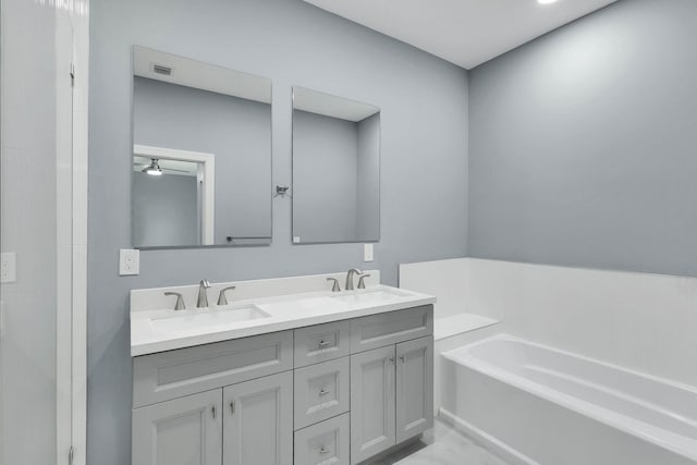 1749 SW California Blvd, Port Saint Lucie, FL 34953 - bathroom with a garden tub, double vanity, marble finish floors, and ceiling fan