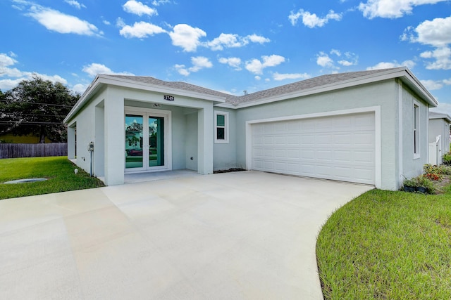 ranch-style home with a garage and a front lawn