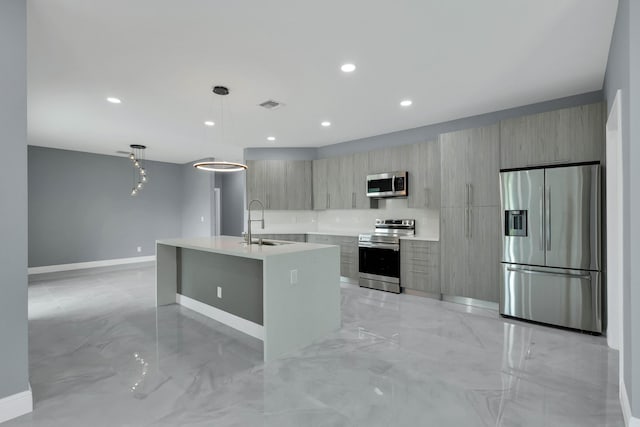 1749 SW California Blvd, Port Saint Lucie, FL 34953 - kitchen with stainless steel appliances, modern cabinets, light marble finish flooring, a sink, and recessed lighting