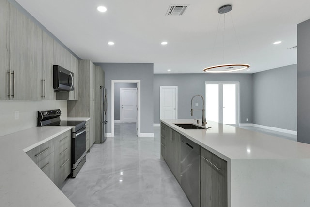 kitchen with pendant lighting, light brown cabinetry, sink, stainless steel appliances, and a spacious island