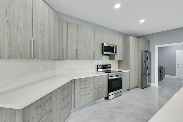 1749 SW California Blvd, Port Saint Lucie, FL 34953 - kitchen with stainless steel appliances, modern cabinets, light countertops, washer / clothes dryer, and recessed lighting