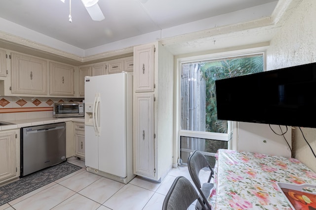 kitchen with ceiling fan, light tile patterned floors, stainless steel dishwasher, white refrigerator with ice dispenser, and decorative backsplash