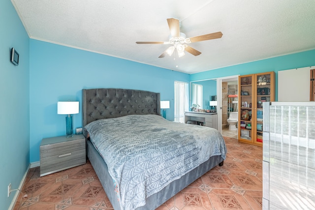 tiled bedroom with ceiling fan, a textured ceiling, and connected bathroom