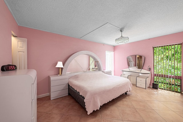 bedroom featuring a textured ceiling and light tile patterned floors