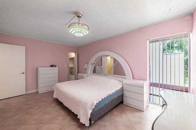 tiled bedroom featuring a textured ceiling