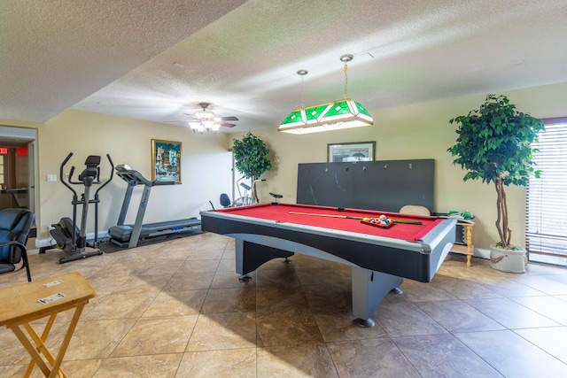 game room with pool table, ceiling fan, and a textured ceiling