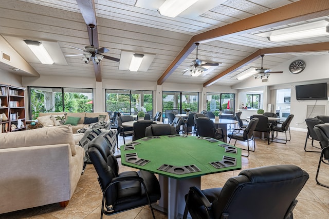 dining room with lofted ceiling with beams, ceiling fan, and plenty of natural light