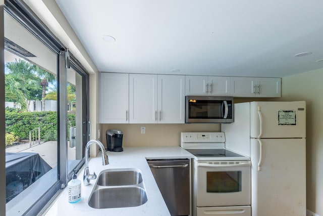 kitchen featuring white cabinets, stainless steel appliances, and sink