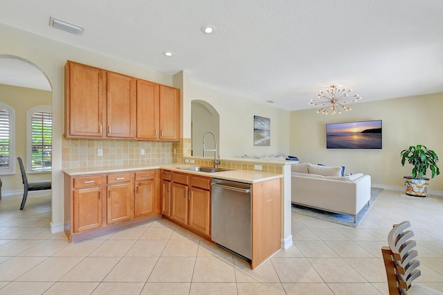 kitchen featuring light tile patterned floors, dishwasher, and sink