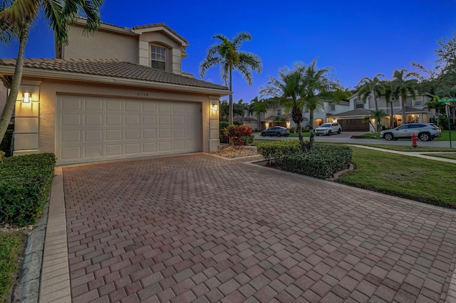 property exterior at dusk with a garage