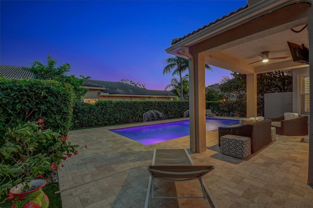 view of swimming pool featuring a patio, an outdoor living space, and ceiling fan