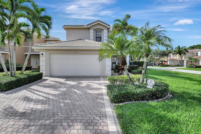 view of front of home featuring a garage and a front yard