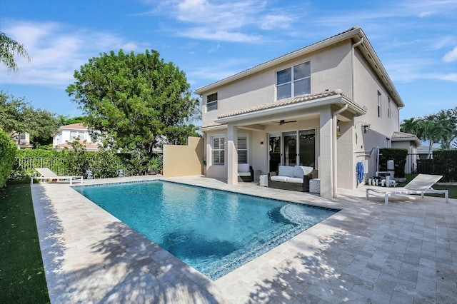 view of swimming pool featuring a patio, ceiling fan, and outdoor lounge area