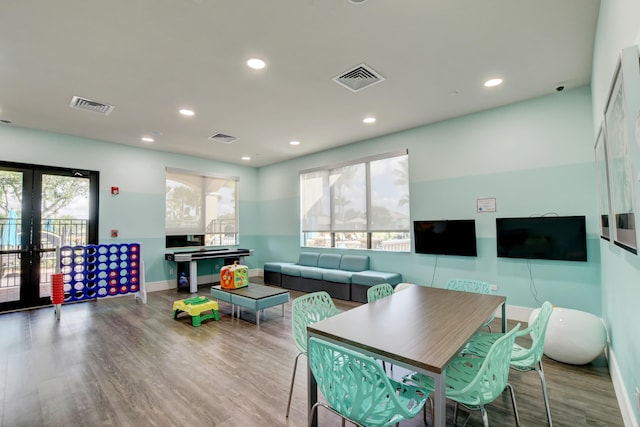 game room with light hardwood / wood-style floors, french doors, and plenty of natural light