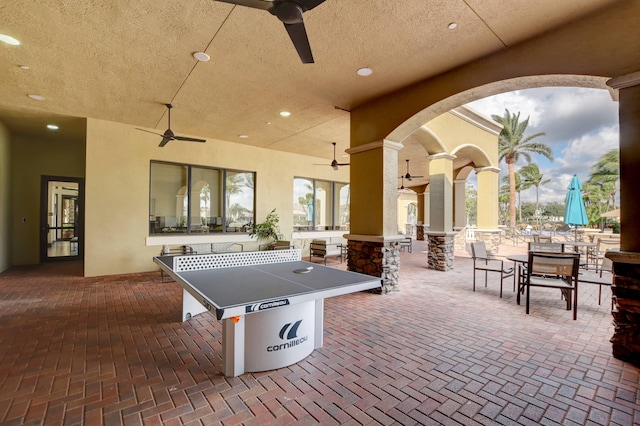 recreation room featuring ceiling fan and a wealth of natural light