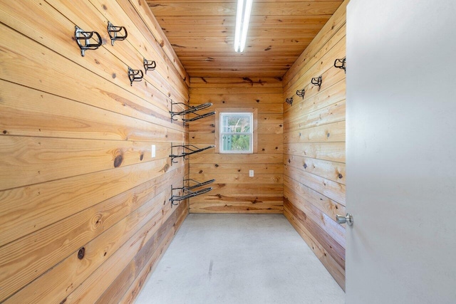 interior space with wood ceiling and wood walls