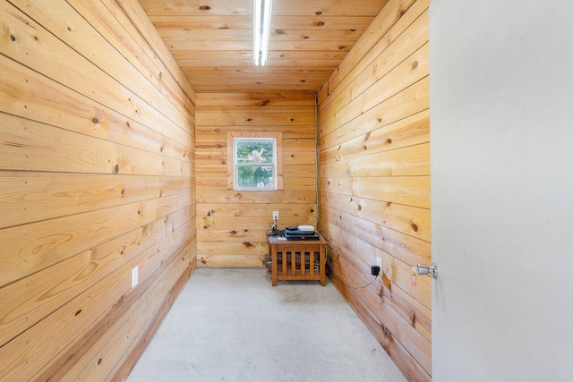 empty room featuring carpet floors, wood ceiling, and wood walls