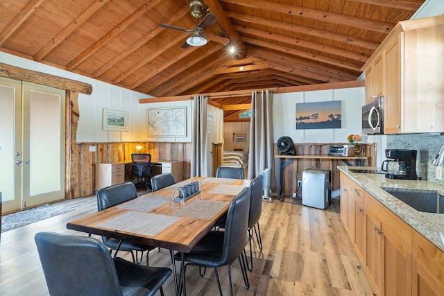 dining area featuring wood ceiling, light hardwood / wood-style flooring, vaulted ceiling with beams, ceiling fan, and french doors