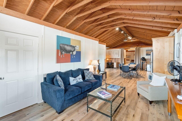 living room featuring lofted ceiling with beams, light wood-type flooring, and wooden ceiling