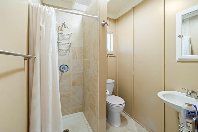 bathroom featuring walk in shower, tile patterned flooring, and toilet