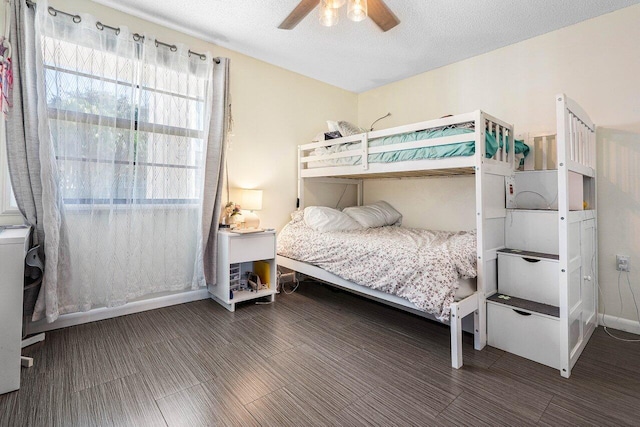 bedroom with ceiling fan and a textured ceiling