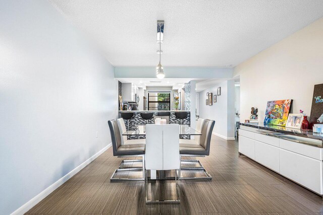 dining room featuring a textured ceiling