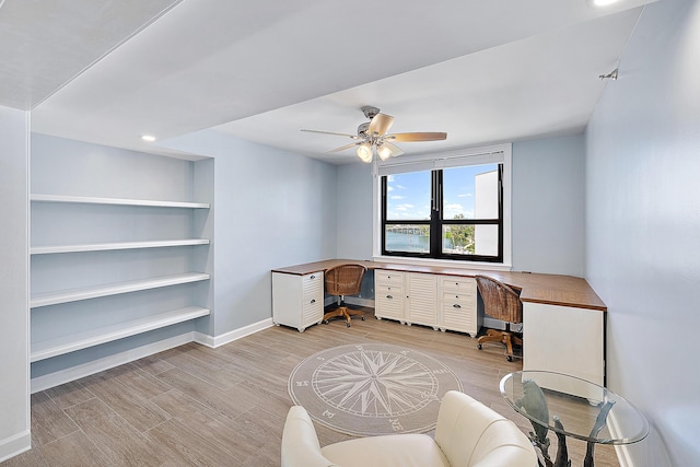 office with light hardwood / wood-style flooring and ceiling fan