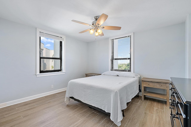 bedroom with ceiling fan and light hardwood / wood-style floors