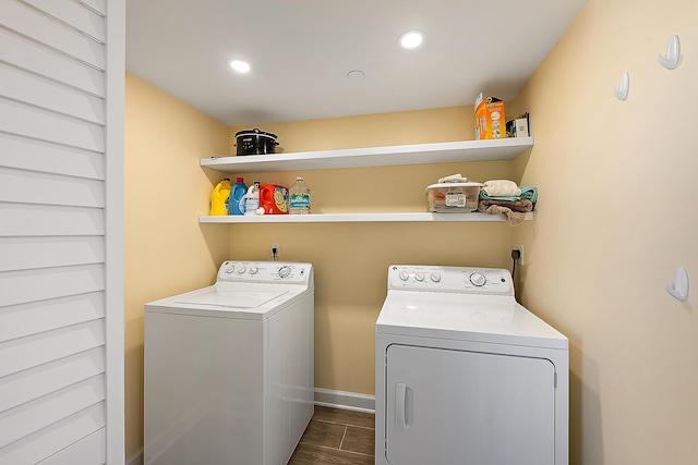 laundry area featuring washer and dryer and dark wood-type flooring