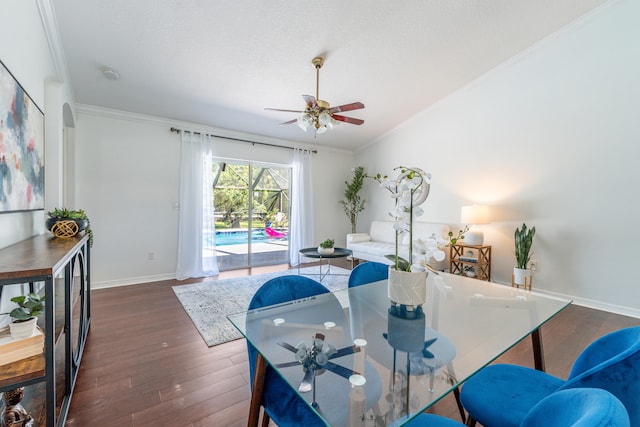 dining room featuring ornamental molding, dark wood-type flooring, and ceiling fan