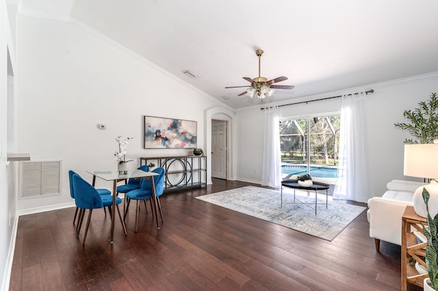 dining room featuring ceiling fan, ornamental molding, lofted ceiling, and dark wood-type flooring